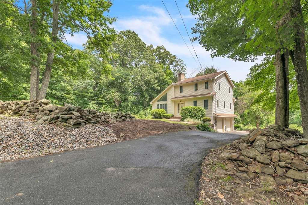 81 Munn Road Monson, MA 01057 - Photo 3 of 42 a front view of a house with a garden
