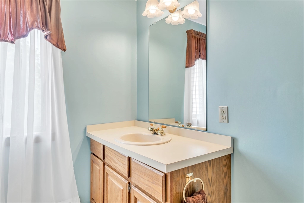 81 Munn Road Monson, MA 01057 - Photo 37 of 42 a bathroom with a sink vanity and a mirror
