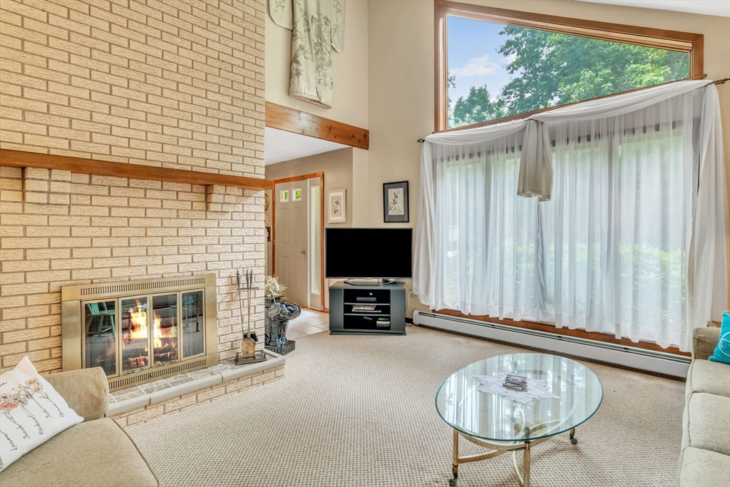 81 Munn Road Monson, MA 01057 - Photo 8 of 42 a living room with furniture a fireplace and a flat screen tv