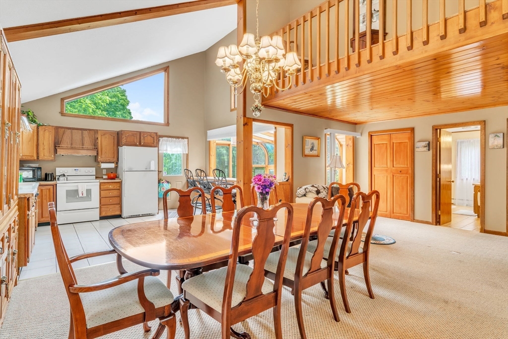 81 Munn Road Monson, MA 01057 - Photo 9 of 42 a dining room with furniture a large window and a chandelier