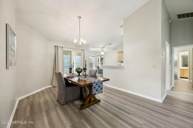 a living room with lots of furniture and kitchen view