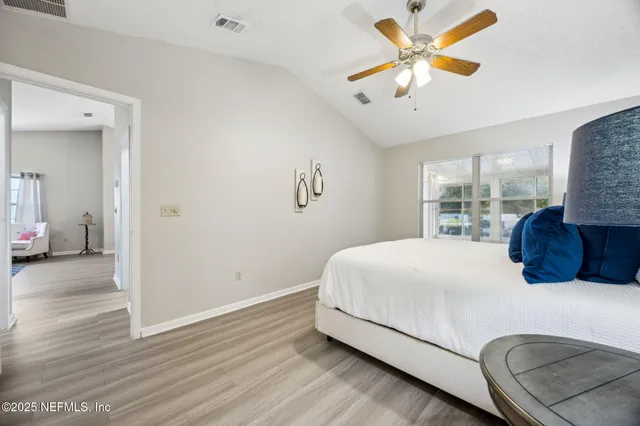 a bedroom with a bed and a lamp