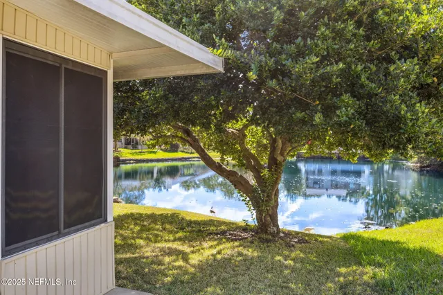 a view of an house with backyard space and balcony