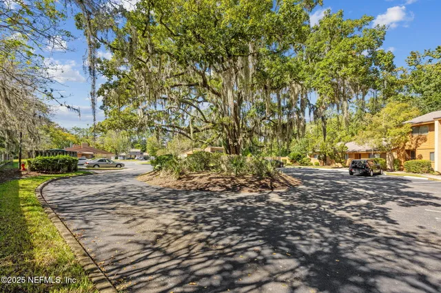 an aerial view of a house with swimming pool and patio