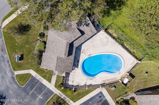a view of a white house with a yard and sitting area