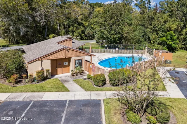 a view of swimming pool with outdoor seating and city view