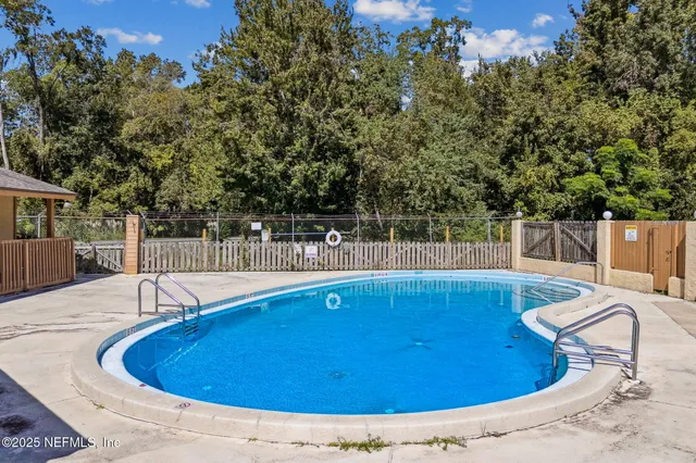 a view of a swimming pool with chairs
