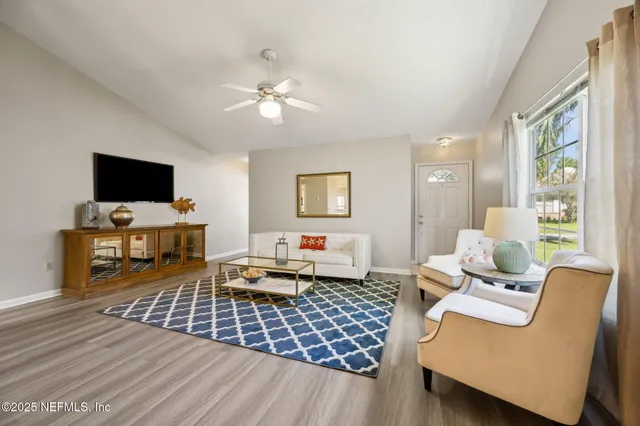 a living room with furniture and a flat screen tv