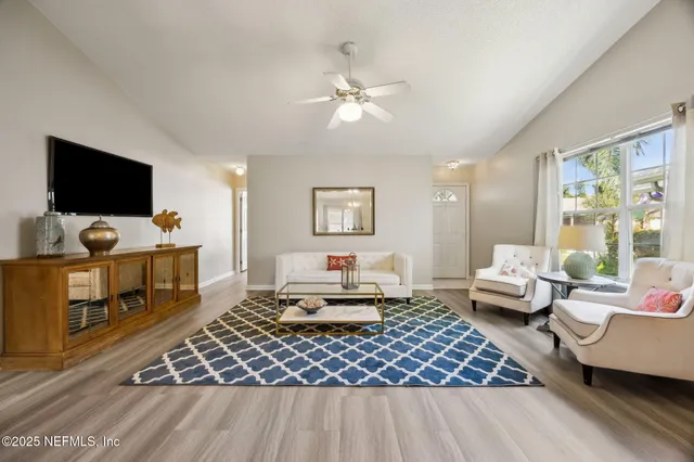 a living room with furniture and a flat screen tv