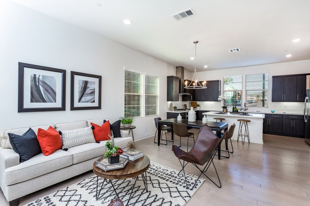 a living room with furniture kitchen and a window