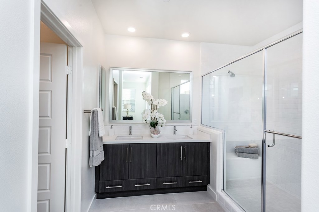 106 Newall Irvine, CA 92618 - Photo 12 of 31 a en suite bathroom with a double vanity sink a mirror and a shower