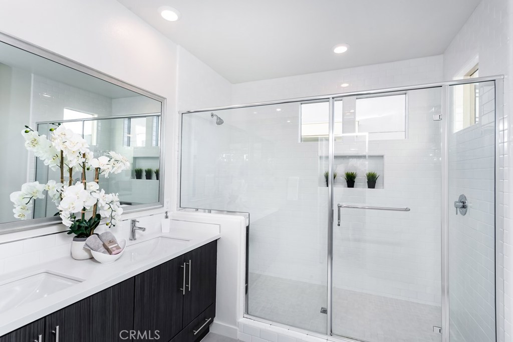 106 Newall Irvine, CA 92618 - Photo 13 of 31 a bathroom with a double vanity sink mirror and shower