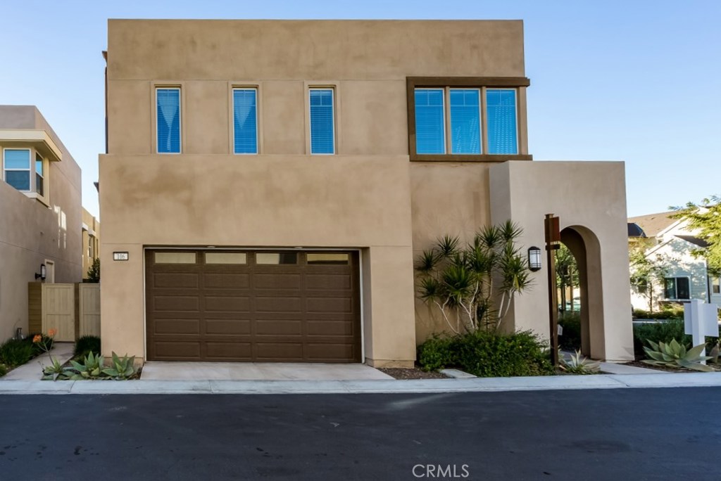 106 Newall Irvine, CA 92618 - Photo 2 of 31 a front view of a house with a yard and garage