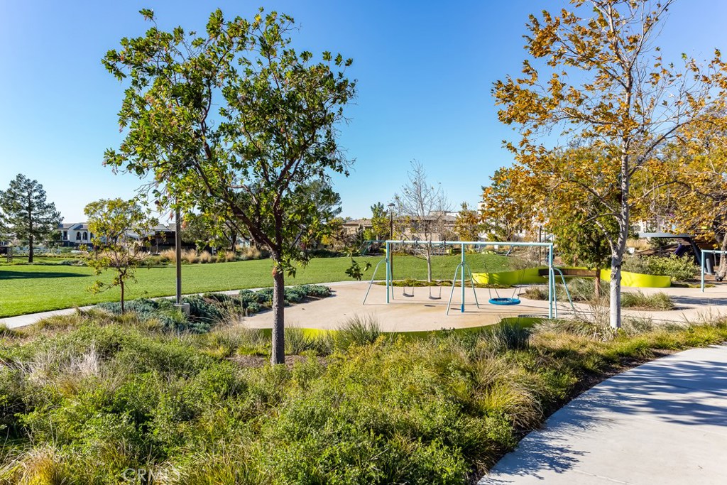 106 Newall Irvine, CA 92618 - Photo 23 of 31 a view of a swimming pool with a bench and trees around