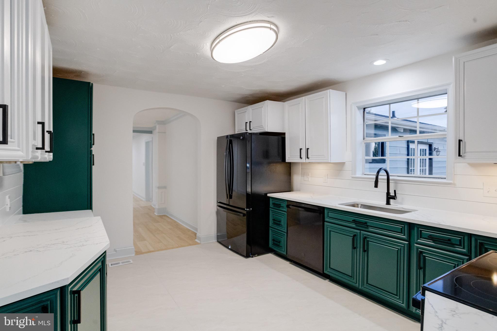 5717 Station Road White Marsh, MD 21162 - Photo 14 of 62 a kitchen with stainless steel appliances a sink stove and refrigerator
