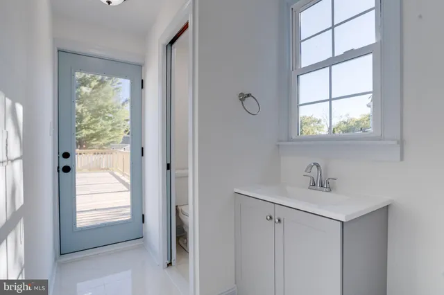 a bathroom with a toilet and a mirror