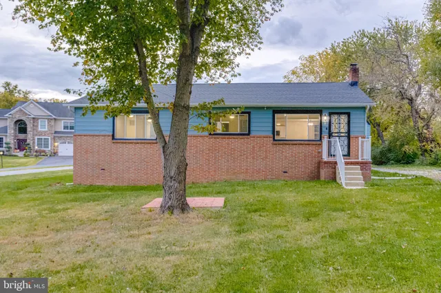 a house that has a tree in front of it