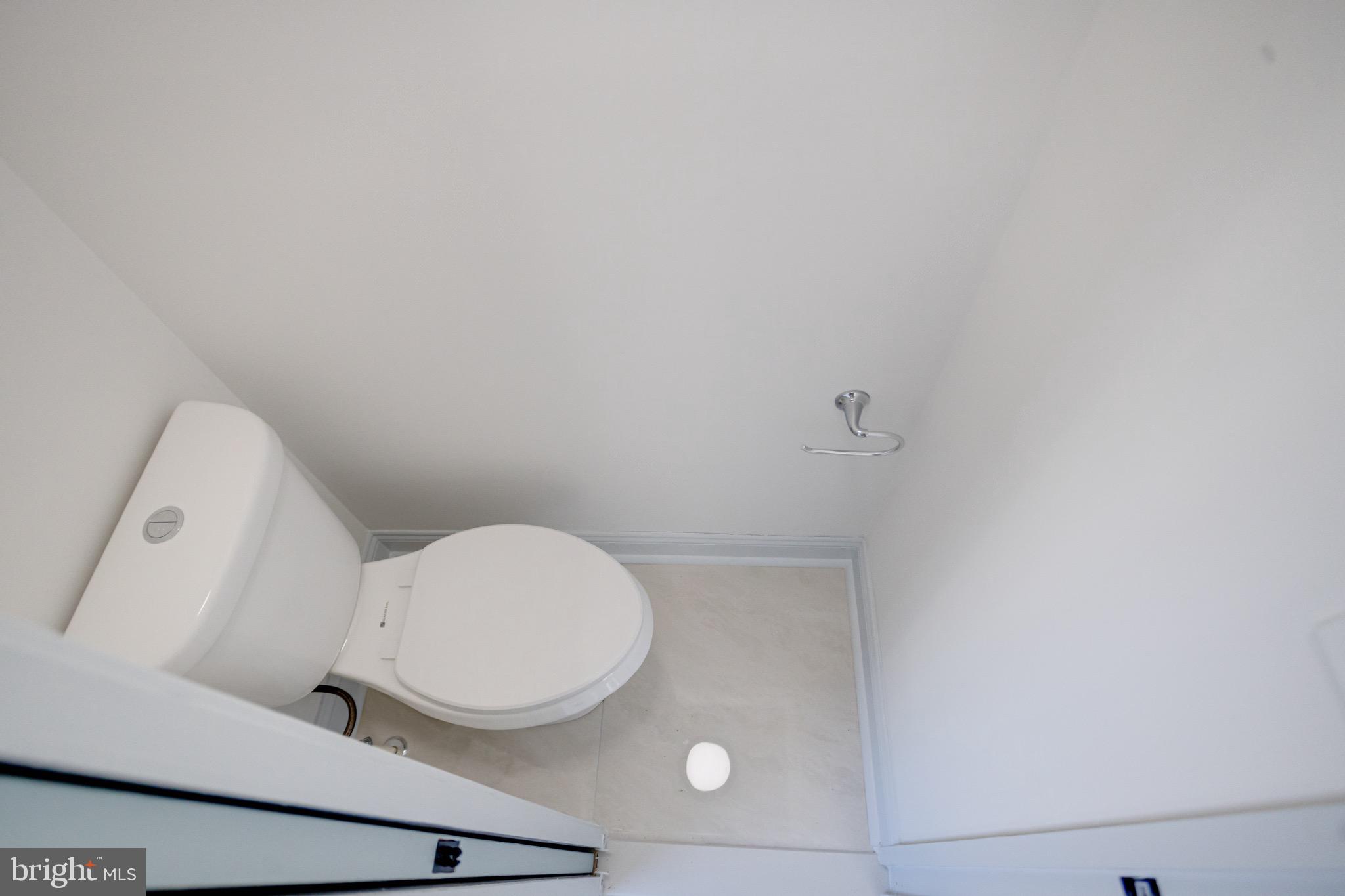 5717 Station Road White Marsh, MD 21162 - Photo 21 of 62 a bathroom with a toilet and a mirror