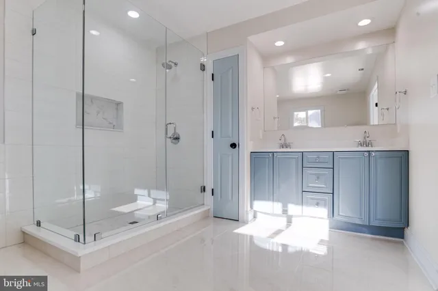 an empty room with closet and a chandelier fan