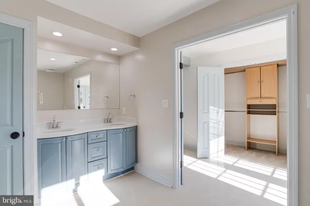 an empty room with closet and windows
