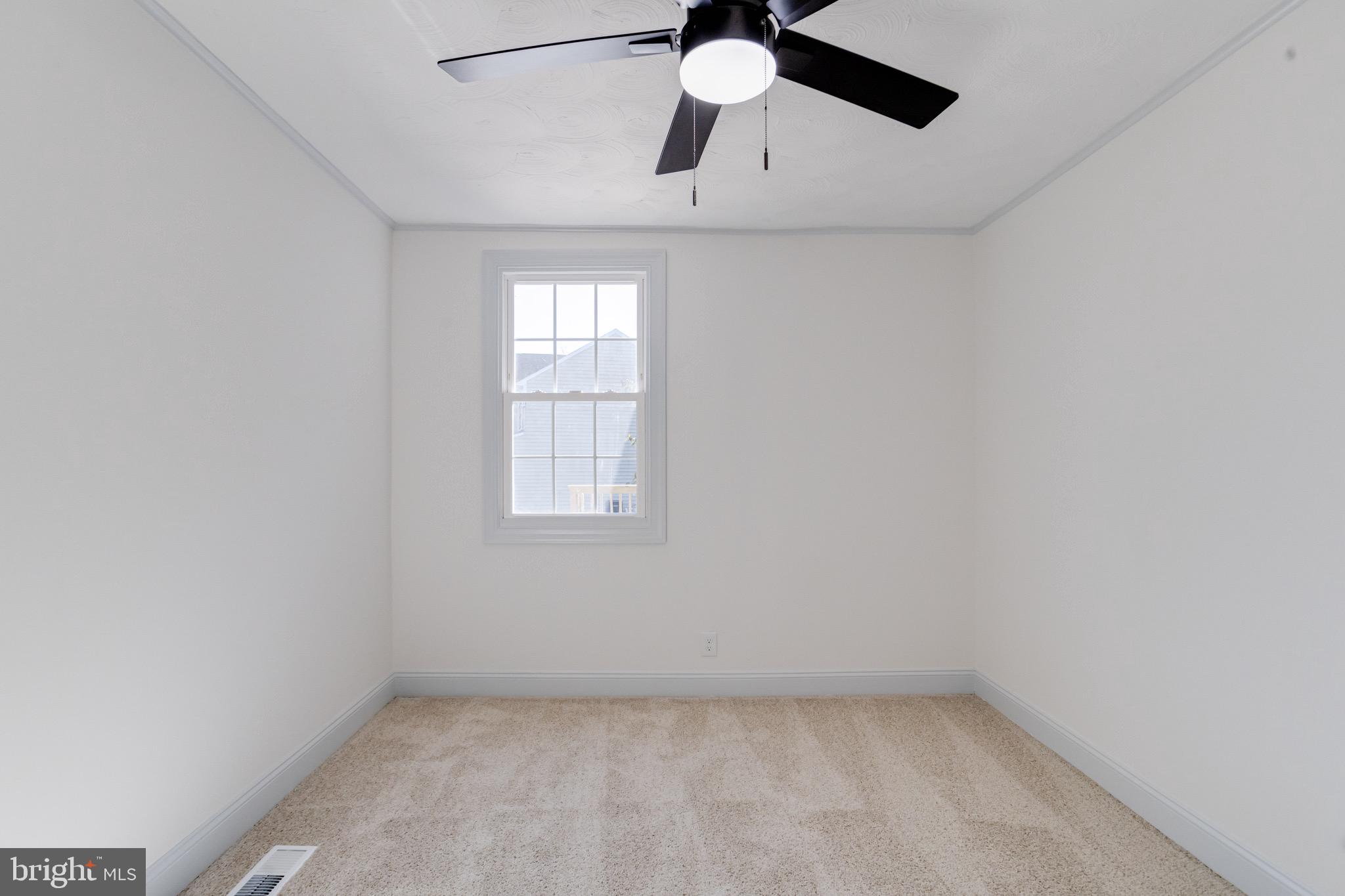 5717 Station Road White Marsh, MD 21162 - Photo 40 of 62 an empty room with a window and a fan