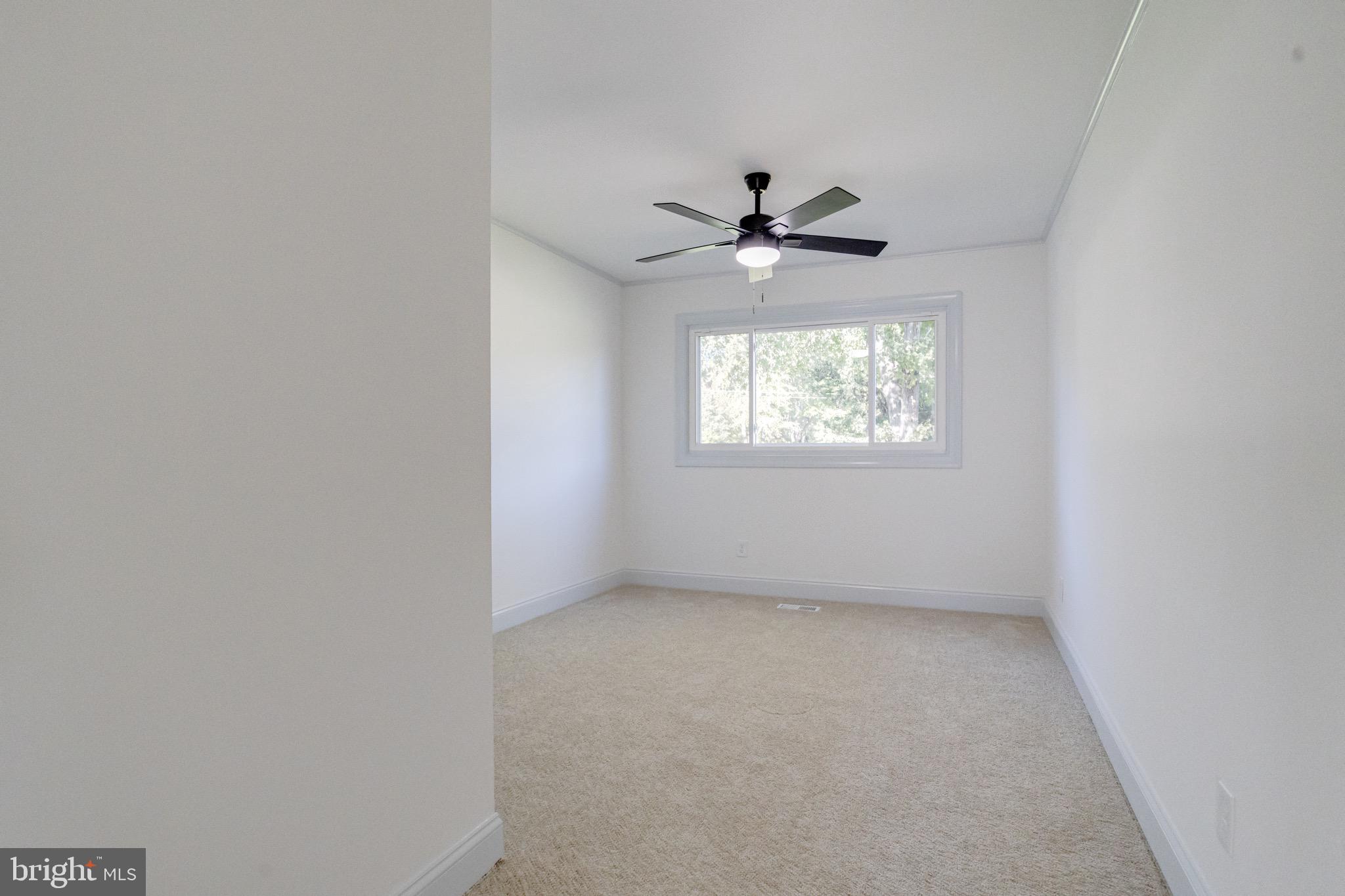 5717 Station Road White Marsh, MD 21162 - Photo 43 of 62 an empty room with windows ceiling fan and window