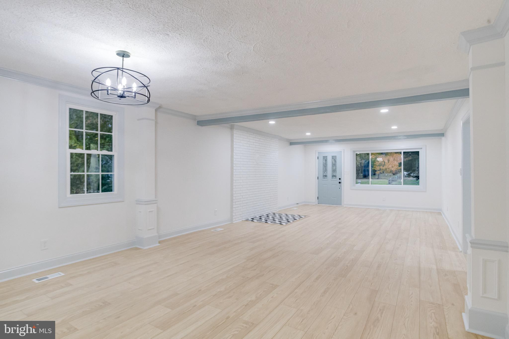5717 Station Road White Marsh, MD 21162 - Photo 10 of 62 a view of an empty room with a window and a chandelier