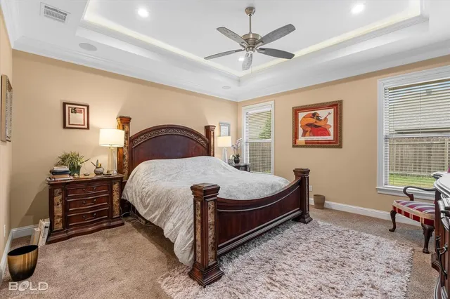 a bedroom with a bed table chair and a window
