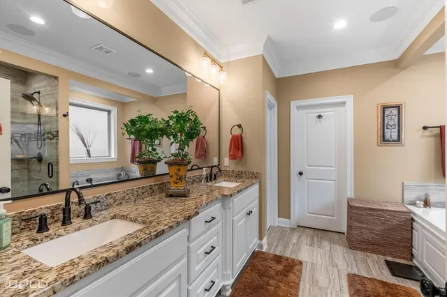 a spacious bathroom with a granite countertop sink mirror and vanity