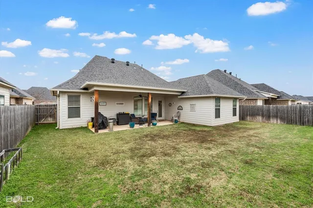 a view of a house with a yard and sitting area