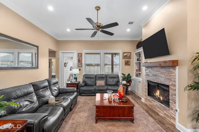 a living room with furniture a fireplace and a flat screen tv