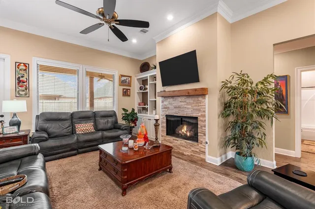 a living room with furniture fireplace and flat screen tv