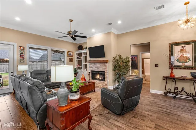 a living room with furniture a fireplace and a flat screen tv