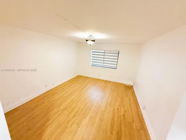 a view of a big room with wooden floor and ceiling fan