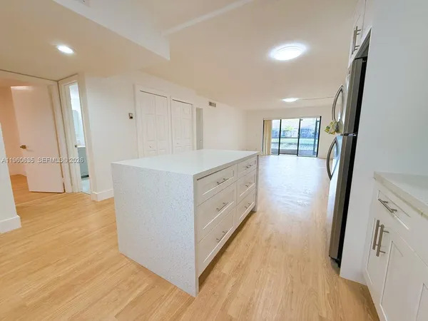 a view of a kitchen cabinets and wooden floor