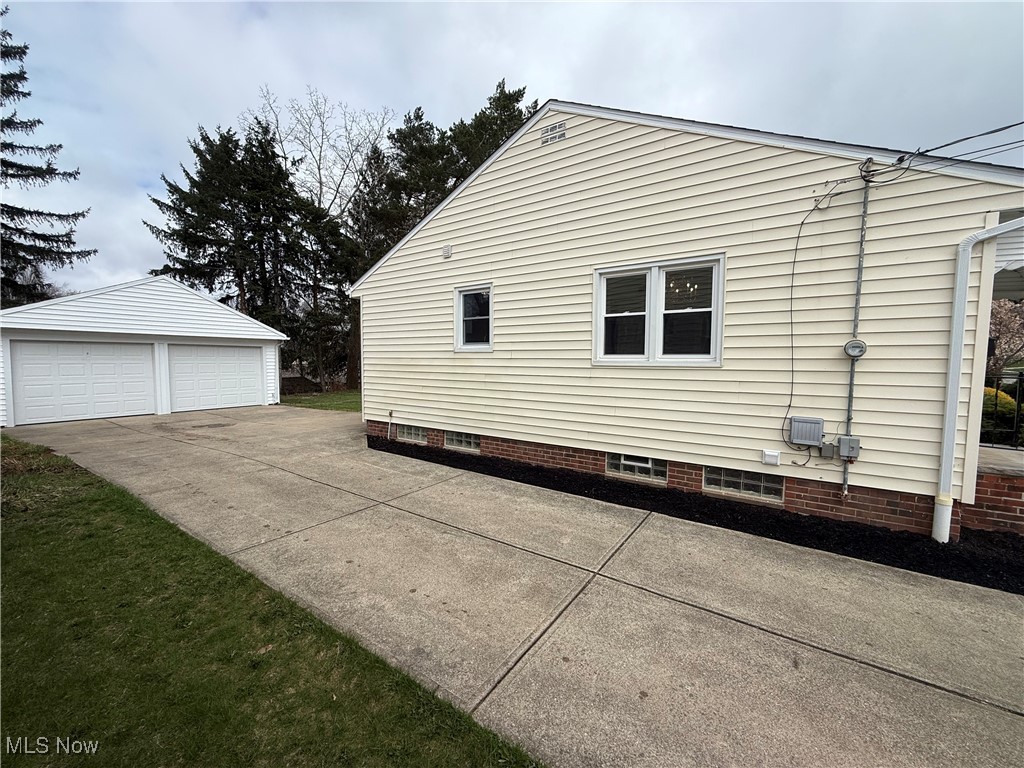 9417 Alexander Road Garfield Heights, OH 44125 - Photo 2 of 38 View of side of home featuring a detached garage and an outdoor structure