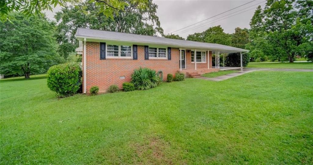 124 Angelo Road Newnan, GA 30263 - Photo 1 of 1 a view of a house with a backyard