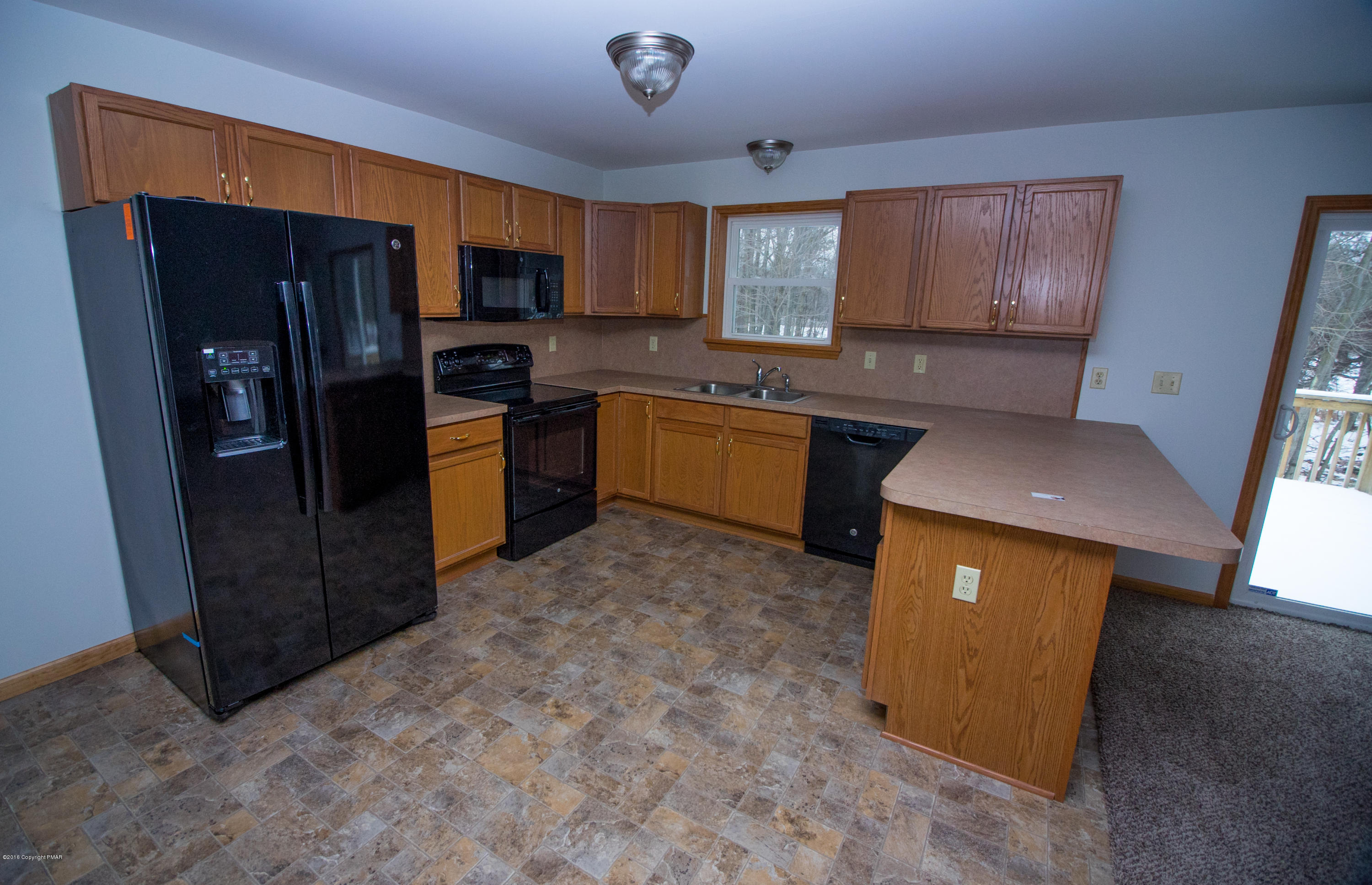 186 Granite Road Long Pond, PA 18334 - Photo 4 of 12 a kitchen with stainless steel appliances granite countertop a refrigerator stove top oven a sink and dishwasher