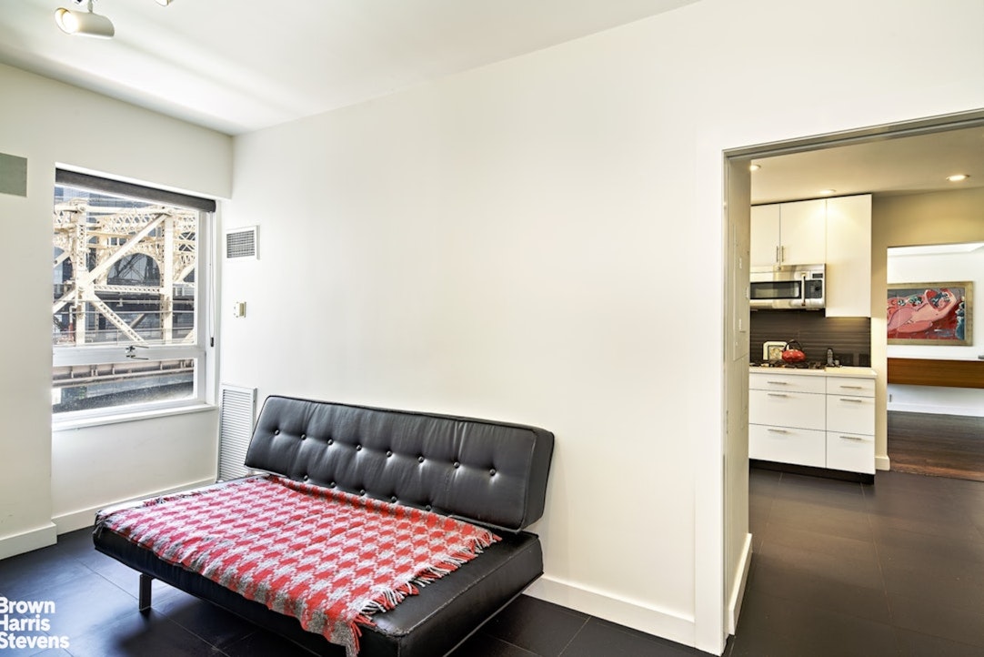 425 East 58th Street, Unit 7D Manhattan, NY 10022 - Photo 12 of 13 a bedroom with a bed and wooden floor