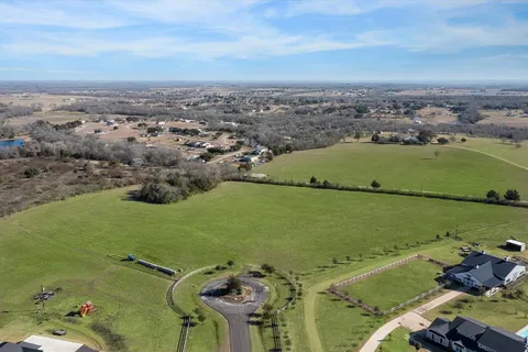 an aerial view of a houses with a lake