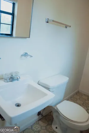 a white toilet sitting next to a bath tub
