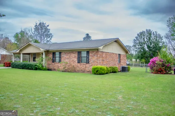 a view of a front of a house with a yard
