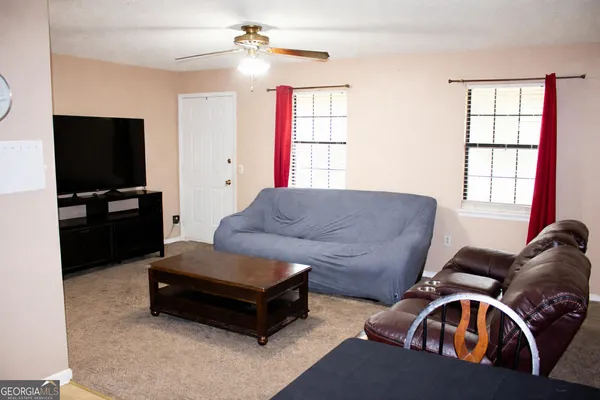 a living room with furniture and a flat screen tv