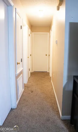 a view of a hallway to rooms