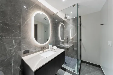 a bathroom with a double vanity sink mirror and