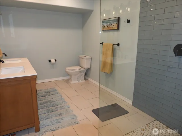 a bathroom with a toilet and a shower