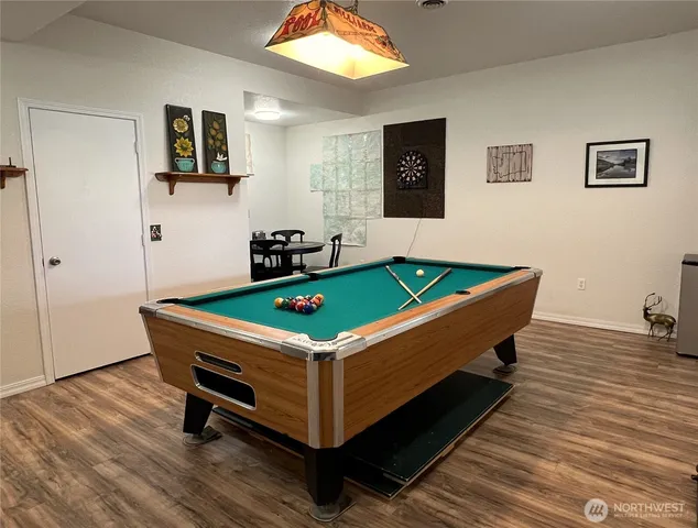 a room with pool table and windows
