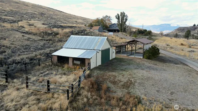 a view of a barn in the middle of a field