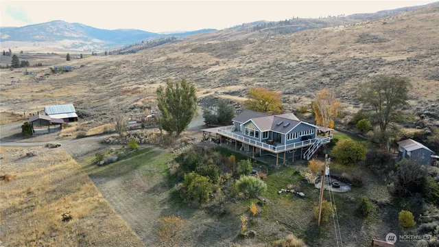 an aerial view of a house with a mountain