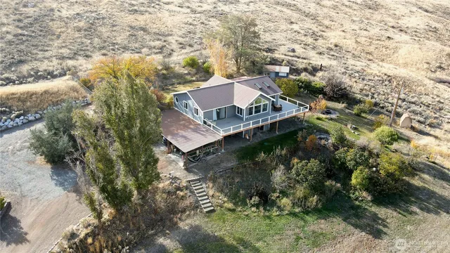 an aerial view of a house with a yard